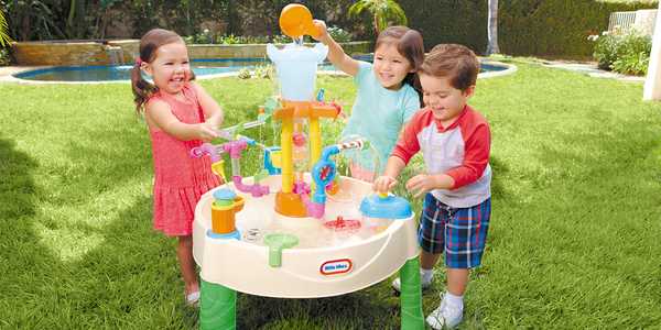3 kids playing with Little Tikes Fountain Factory water table.